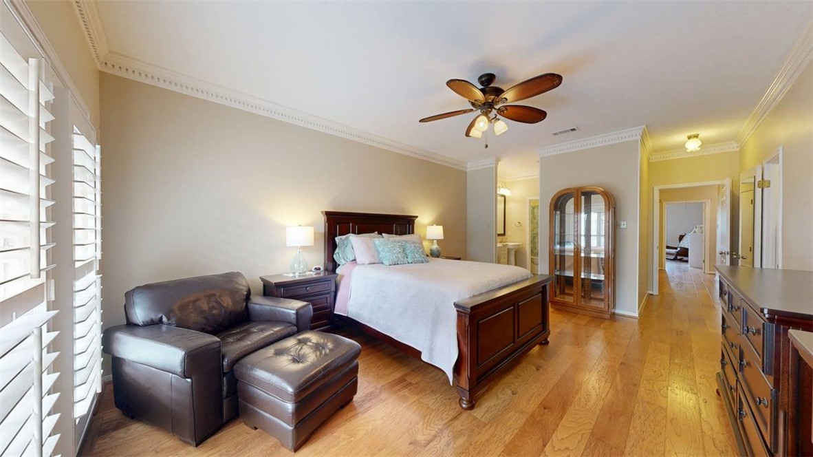 705 Walker Street Bryan, TX 77802 - Photo 22 of 46 a bedroom with a bed and a chandelier