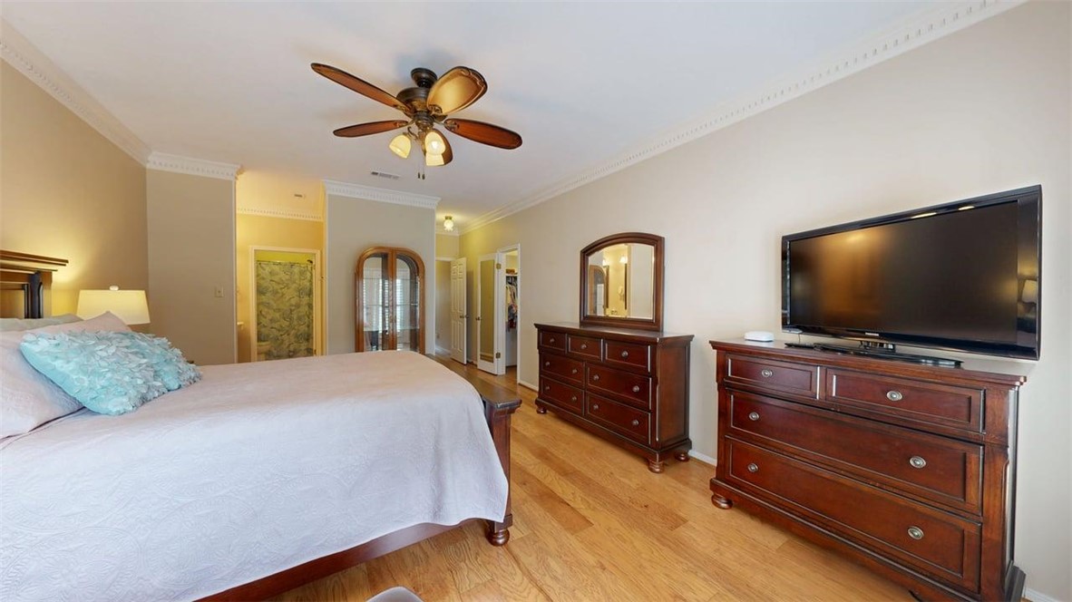 705 Walker Street Bryan, TX 77802 - Photo 23 of 46 a bedroom with a bed and a flat screen tv