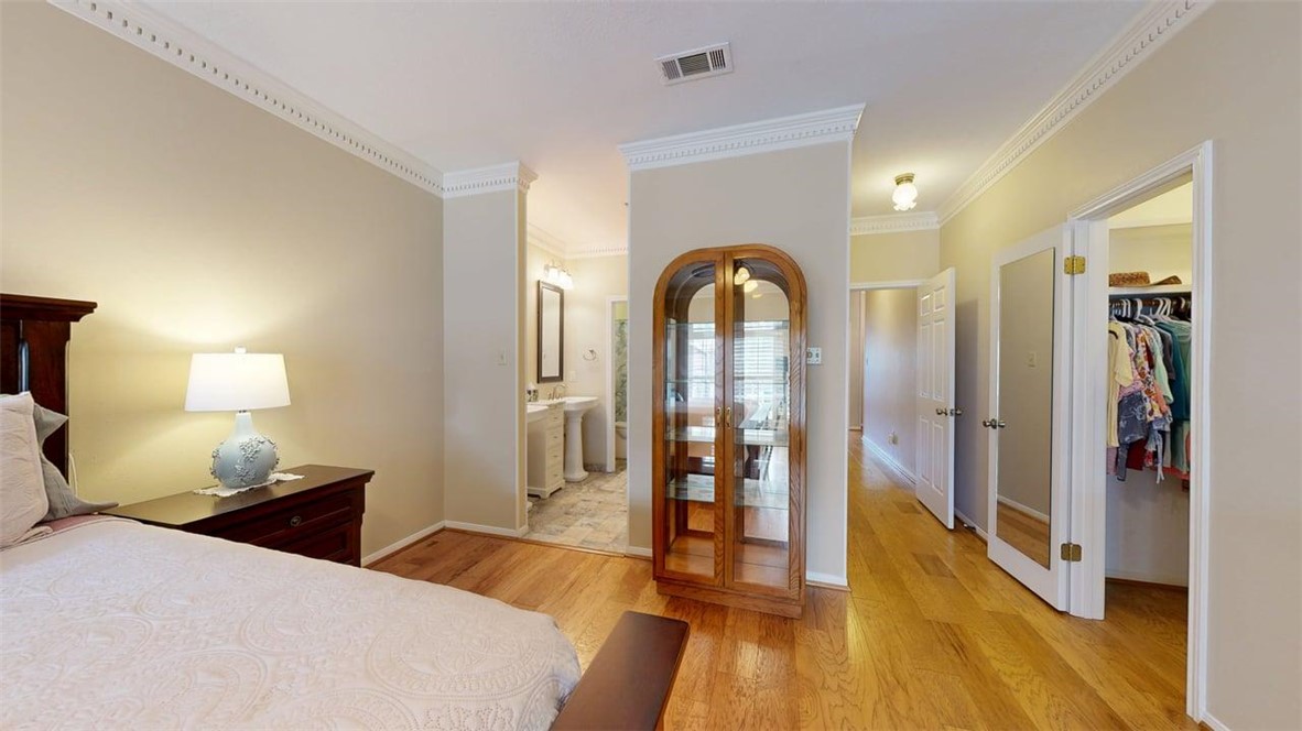 705 Walker Street Bryan, TX 77802 - Photo 24 of 46 a bedroom with a bed and a view of bathroom