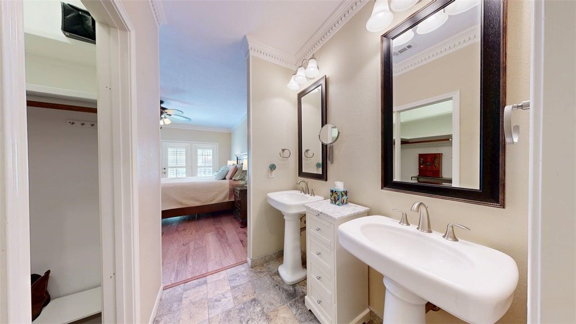 705 Walker Street Bryan, TX 77802 - Photo 26 of 46 a en suite bathroom with a double vanity sink a mirror and a shower