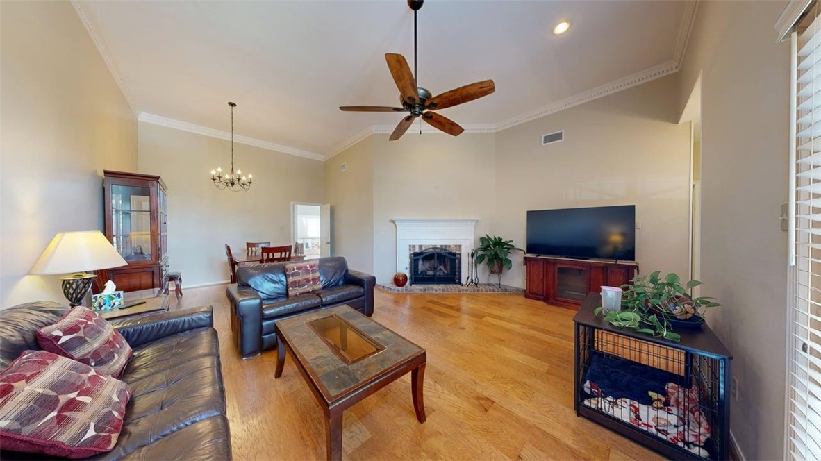 705 Walker Street Bryan, TX 77802 - Photo 4 of 46 a living room with furniture a flat screen tv and a fireplace