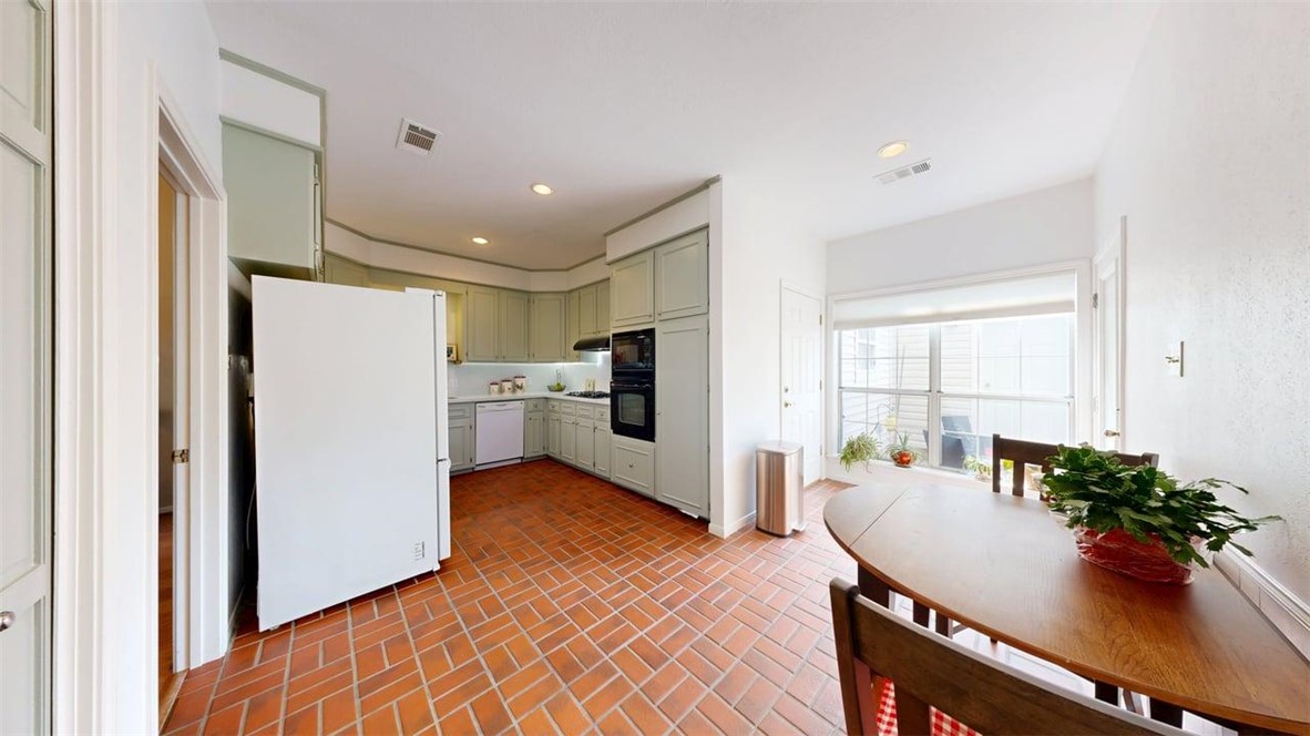 705 Walker Street Bryan, TX 77802 - Photo 6 of 46 a kitchen with stainless steel appliances a refrigerator and a dining table