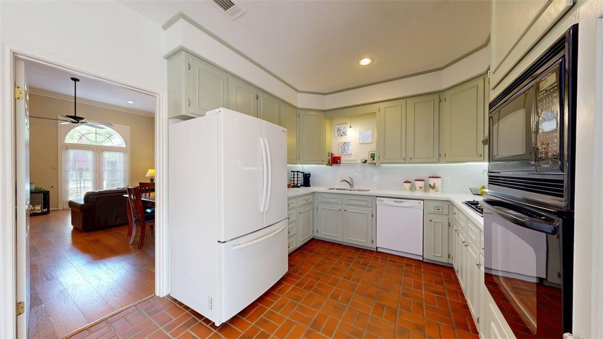 705 Walker Street Bryan, TX 77802 - Photo 8 of 46 a kitchen with a refrigerator sink and cabinets
