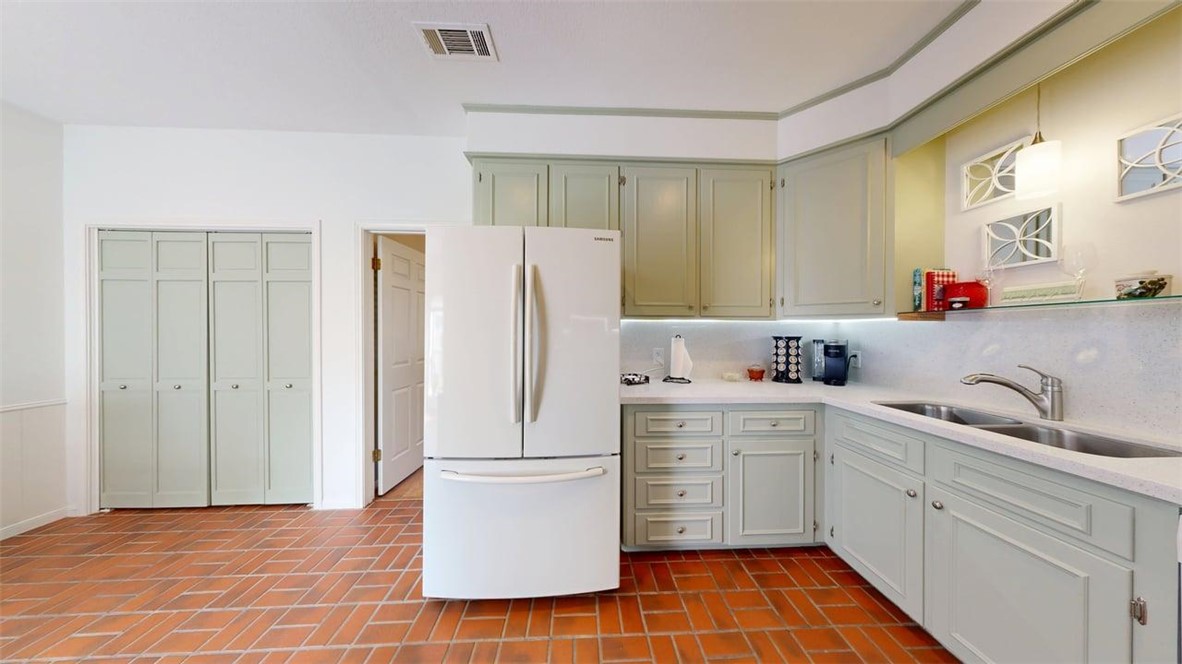 705 Walker Street Bryan, TX 77802 - Photo 9 of 46 a kitchen with a sink a refrigerator and cabinets