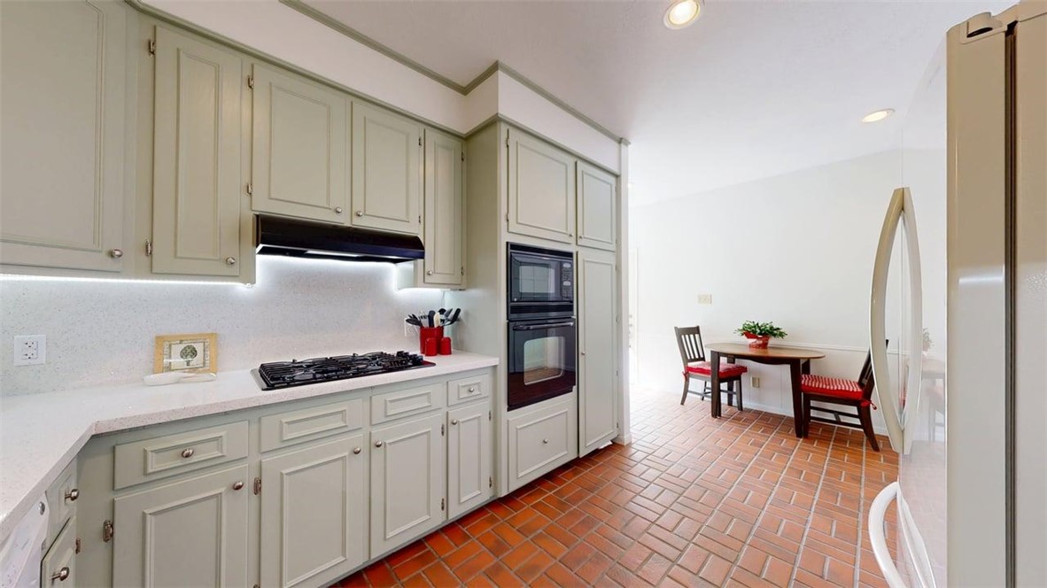 705 Walker Street Bryan, TX 77802 - Photo 10 of 46 a kitchen with cabinets and wooden floor