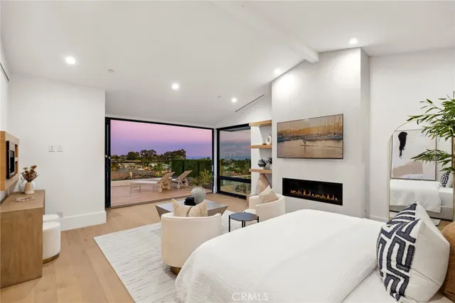 a living room with furniture kitchen view and a large window
