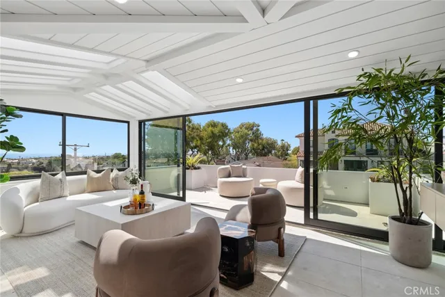a balcony with furniture and a potted plant