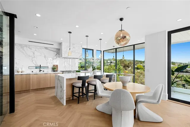 a large living room with stainless steel appliances granite countertop furniture a fireplace and a flat screen tv