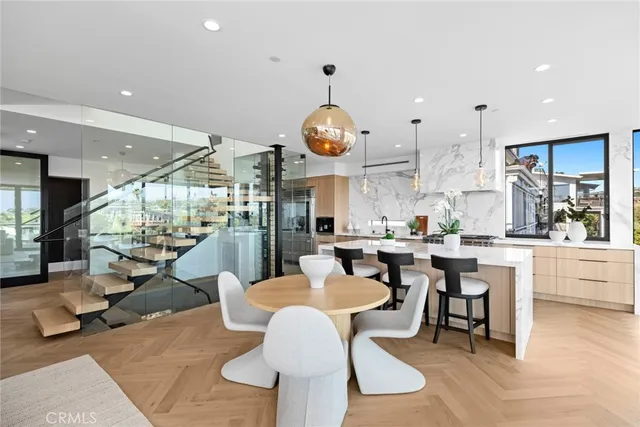 a large kitchen with stainless steel appliances a lot of white cabinets