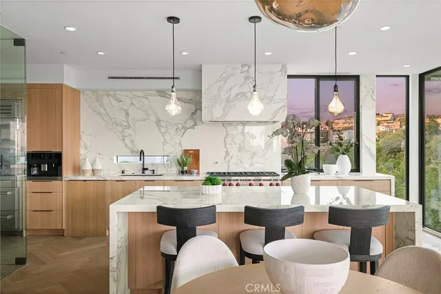 a large kitchen with a table and chairs