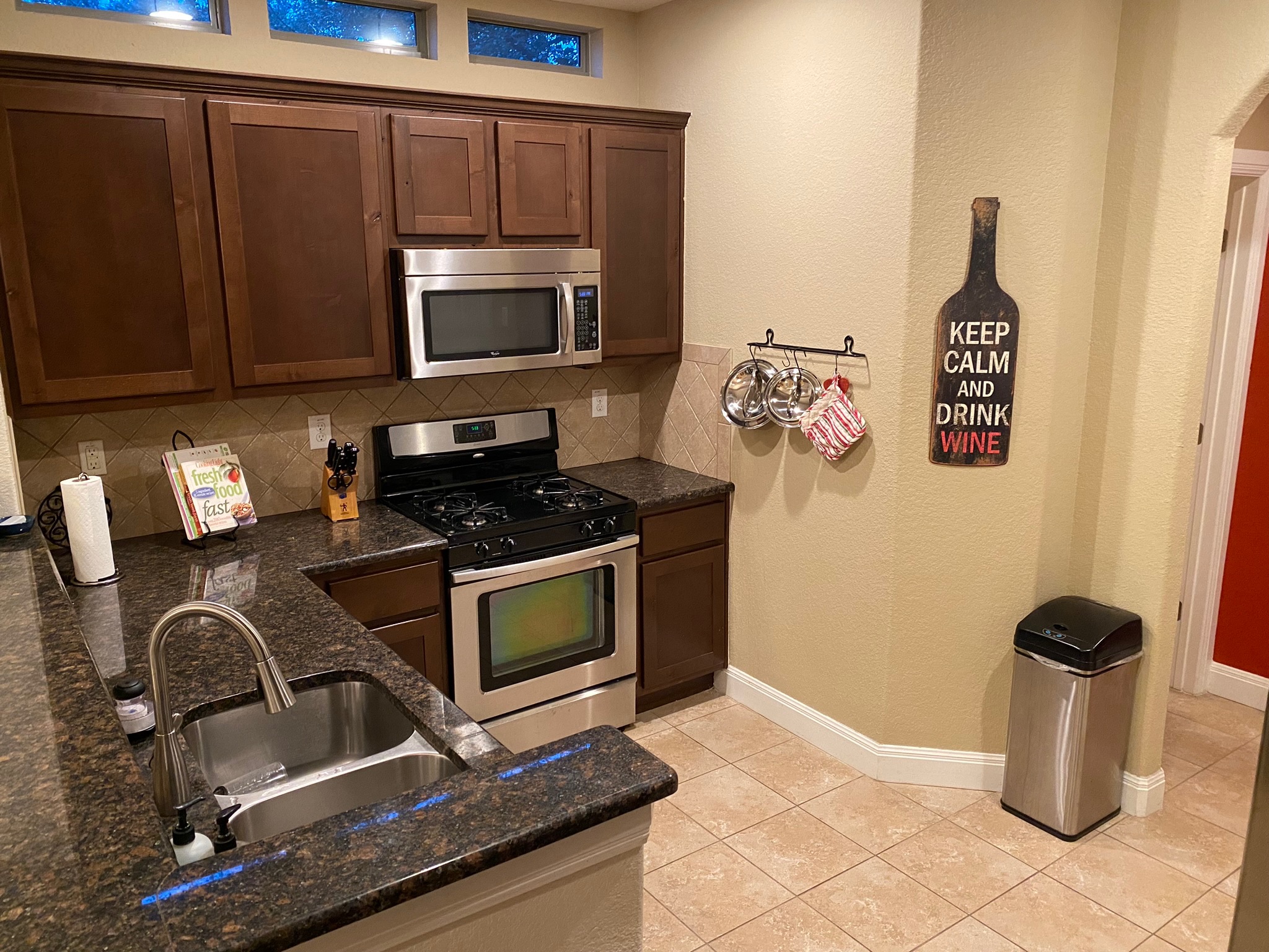 6708 Menchaca Road, Unit 25 Austin, TX 78745 - Photo 5 of 19 Rich wood cabinetry and stone counters define this well-appointed kitchen space.