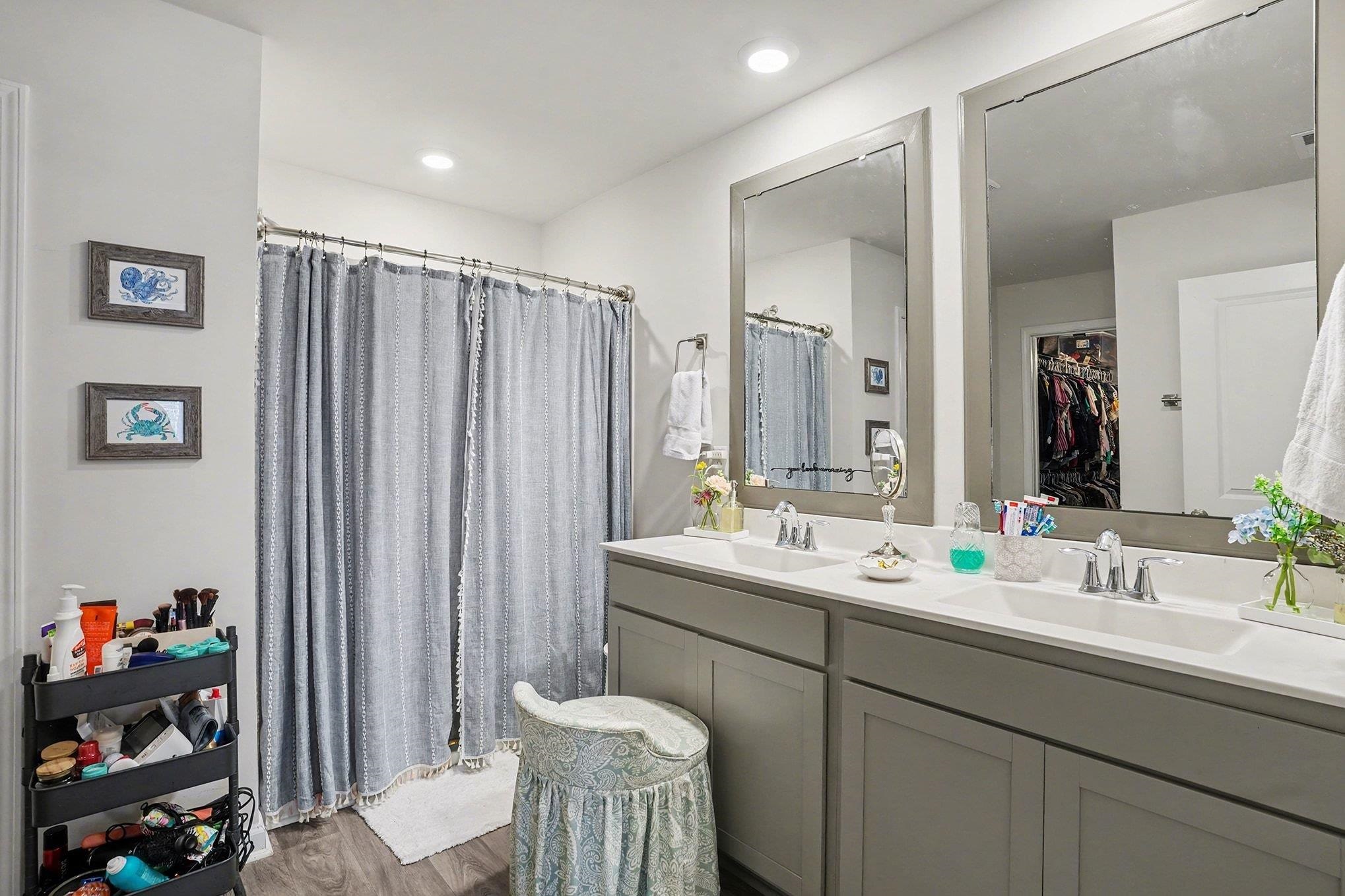 172 Seasons Trace Loop Longs, SC 29568 - Photo 23 of 37 Full bath with double vanity, a shower with shower curtain, a walk in closet, and dark wood finished floors