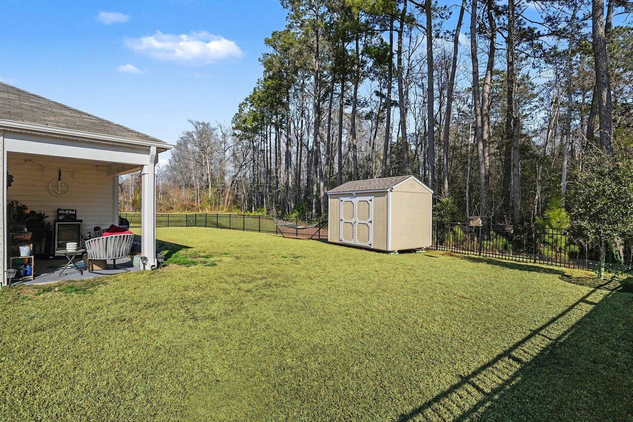 172 Seasons Trace Loop Longs, SC 29568 - Photo 30 of 37 Fenced backyard with a storage shed and a patio area