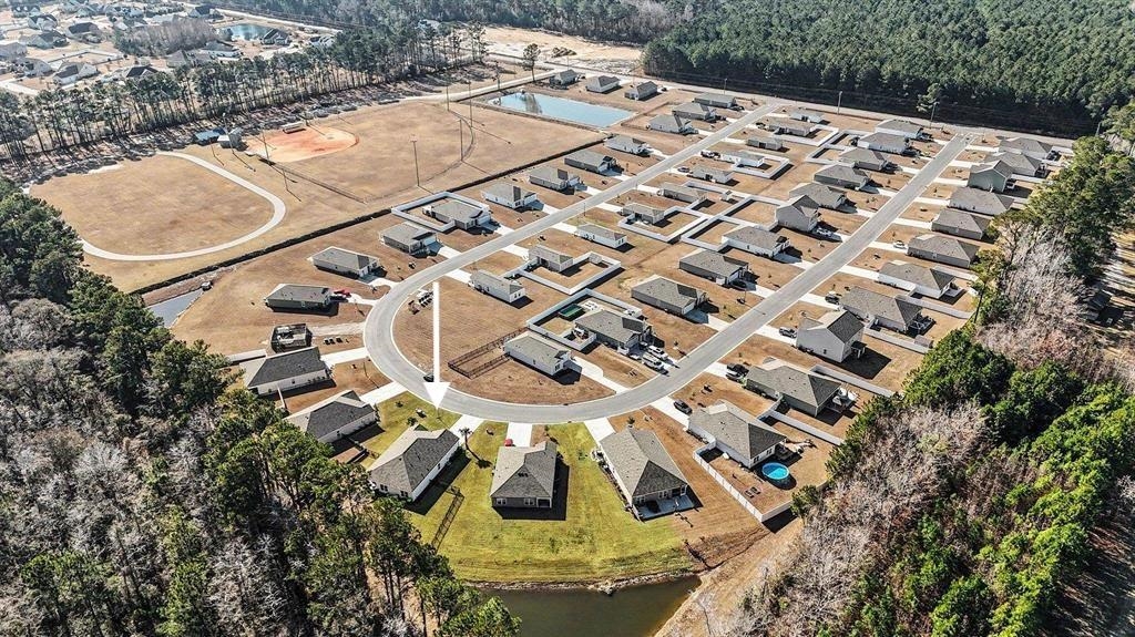 172 Seasons Trace Loop Longs, SC 29568 - Photo 3 of 37 Aerial view of property's location with nearby suburban area and a large body of water