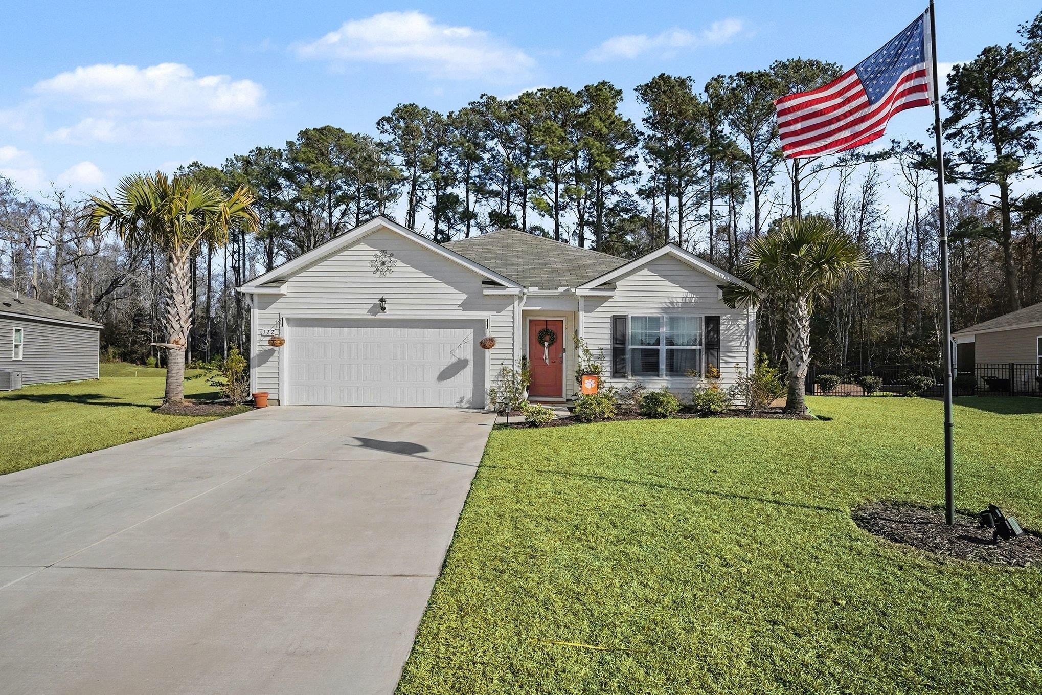 172 Seasons Trace Loop Longs, SC 29568 - Photo 4 of 37 Ranch-style home with a front yard, driveway, an attached garage, and a shingled roof
