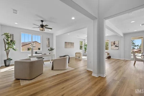 a living room with furniture and wooden floor