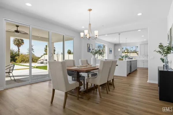 a dining room with furniture a chandelier and wooden floor