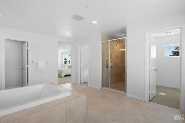 a bathroom with a bathtub shower and a sink
