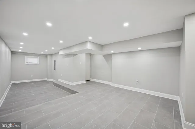 an empty room with a projector space and windows