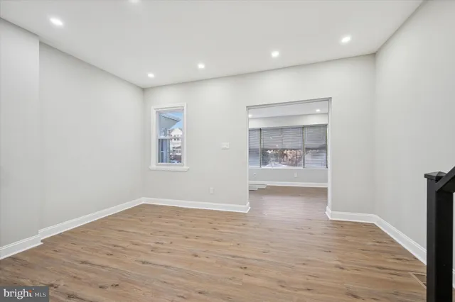 a view of hallway with wooden floor