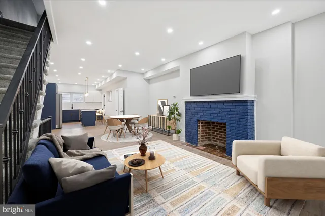 a living room with furniture fireplace and a flat screen tv