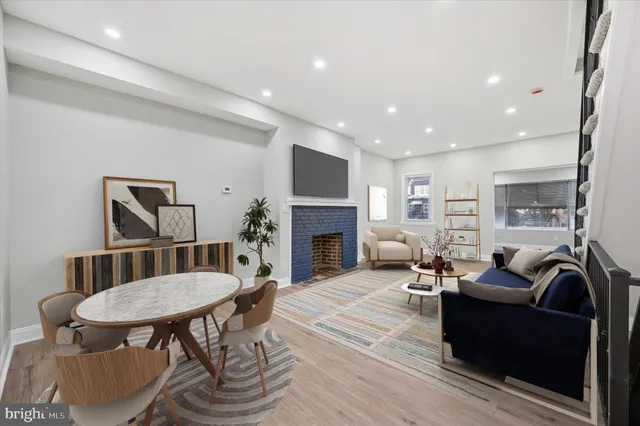 a living room with furniture a table and a fireplace