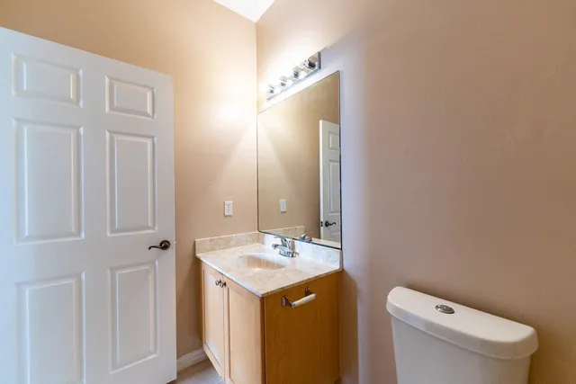 a bathroom with a sink a toilet and a mirror