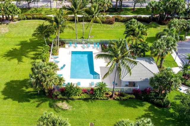 a view of a house with a yard and lake view