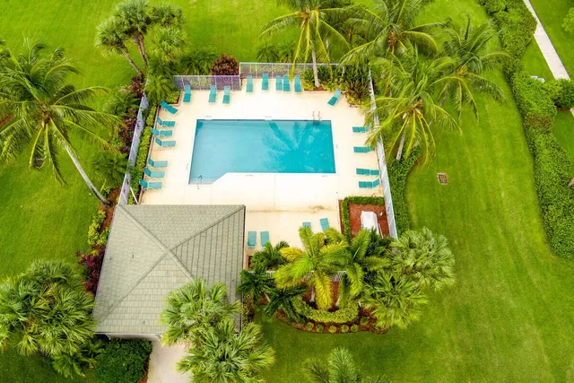 a swimming pool with outdoor seating and yard