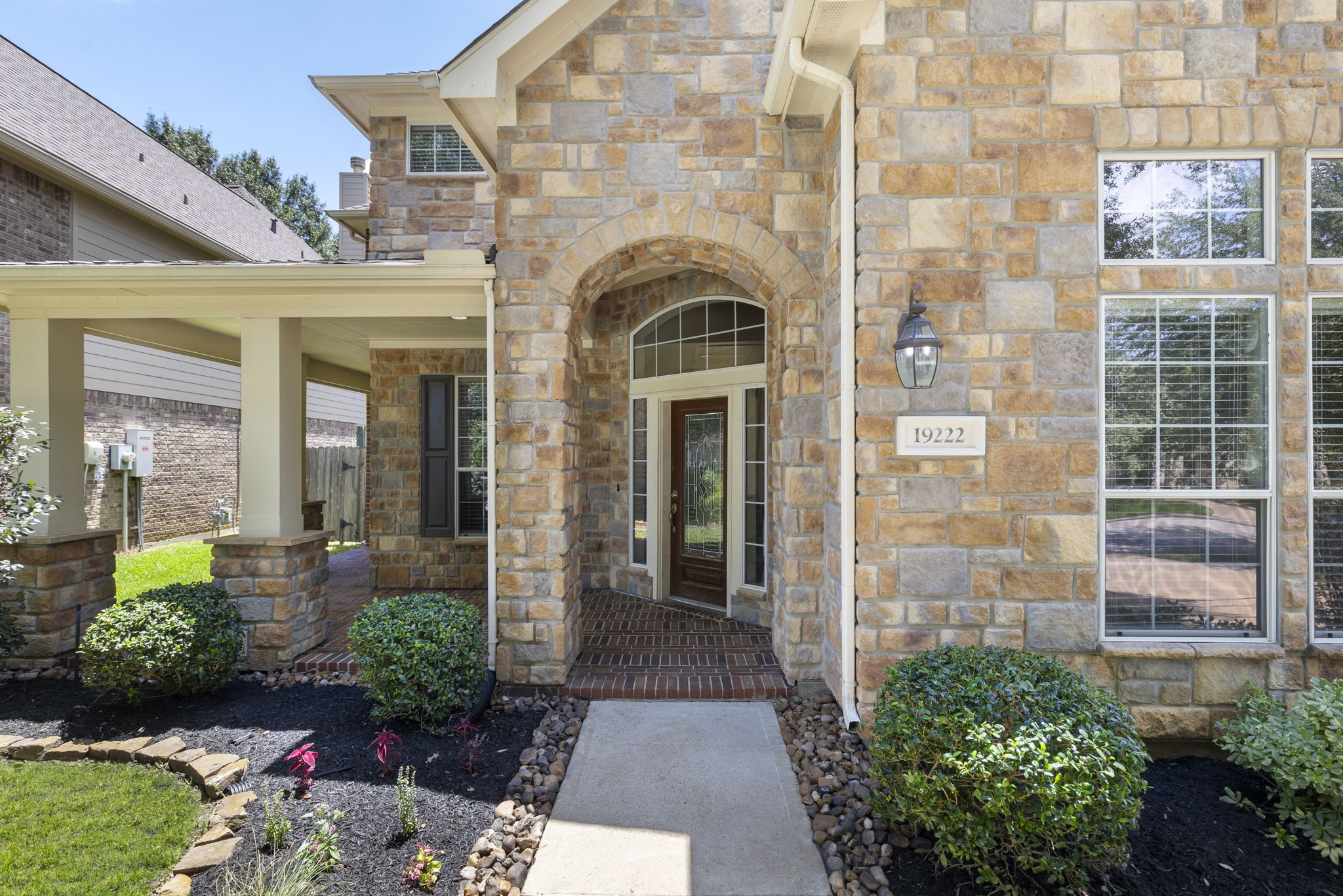 19222 Senterra Lakes Boulevard Spring, TX 77379 - Photo 4 of 45 Up-close look at the grand front entry, featuring custom stone architectural arches and a classic, welcoming front door.
