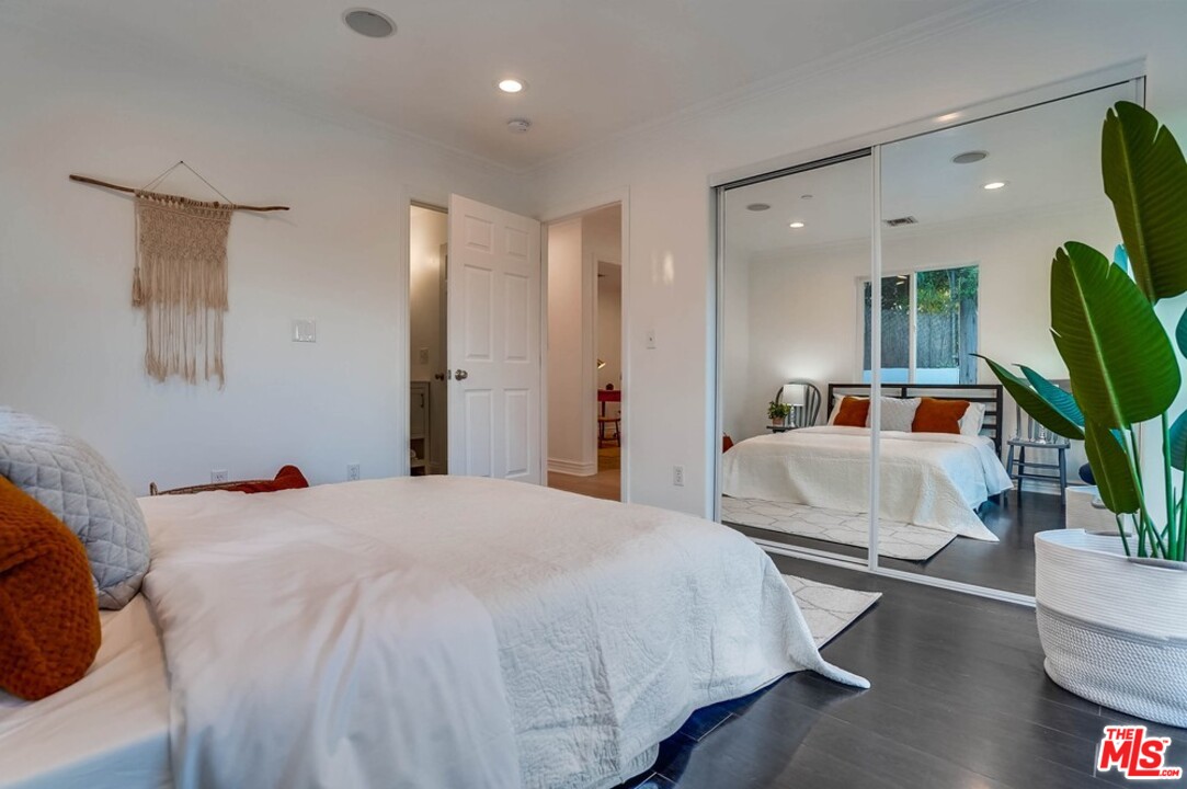 2049 Rome Drive Los Angeles, CA 90065 - Photo 23 of 43 a bedroom with a bed wooden floor and a large mirror