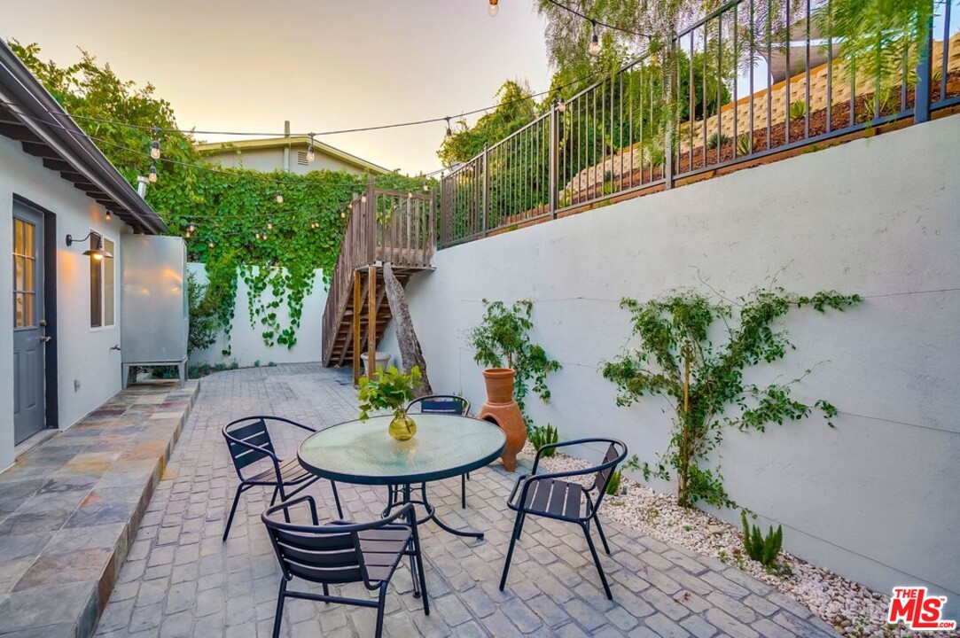 2049 Rome Drive Los Angeles, CA 90065 - Photo 29 of 43 a backyard of a house with table and chairs with plants