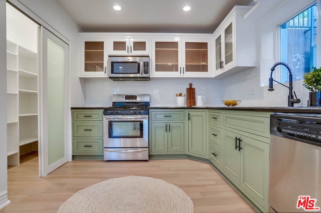 2049 Rome Drive Los Angeles, CA 90065 - Photo 7 of 43 a kitchen with stainless steel appliances granite countertop a stove and a sink