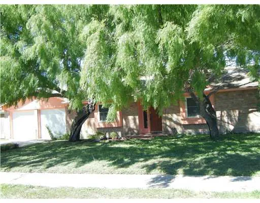 a view of a house with a backyard