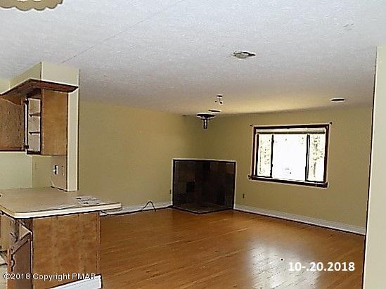 4152 Blueberry Hill Road Bushkill, PA 18324 - Photo 4 of 25 a view of a livingroom with an empty space and a window