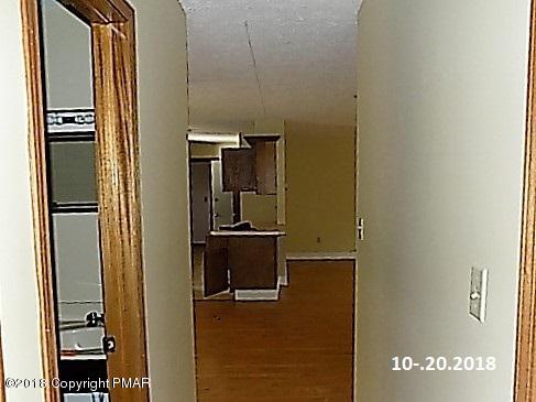 4152 Blueberry Hill Road Bushkill, PA 18324 - Photo 6 of 25 a kitchen with a refrigerator and cabinets