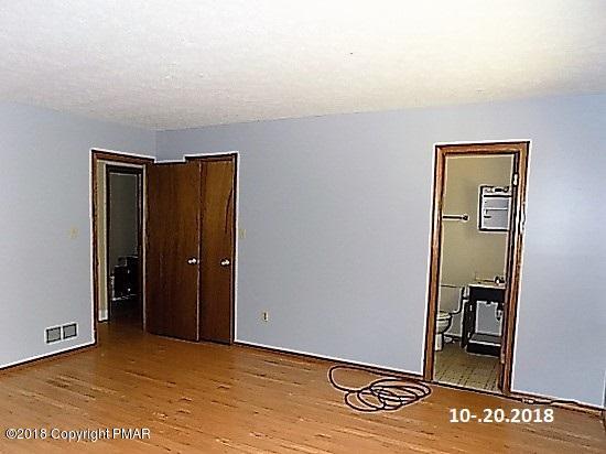 4152 Blueberry Hill Road Bushkill, PA 18324 - Photo 8 of 25 an empty room with wooden floor and closet