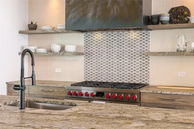 a kitchen with stainless steel appliances granite countertop a stove and a sink