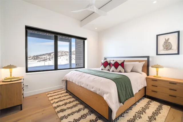 a bathroom with a granite countertop toilet sink and mirror