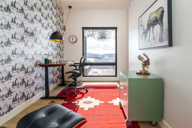 a view of a backyard with table and chairs under an umbrella