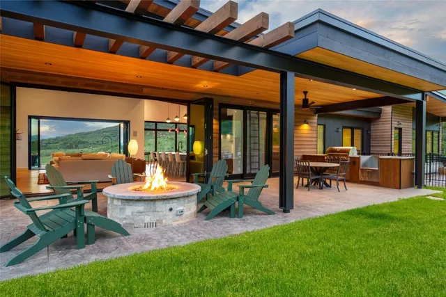 a view of a patio with table and chairs and potted plants
