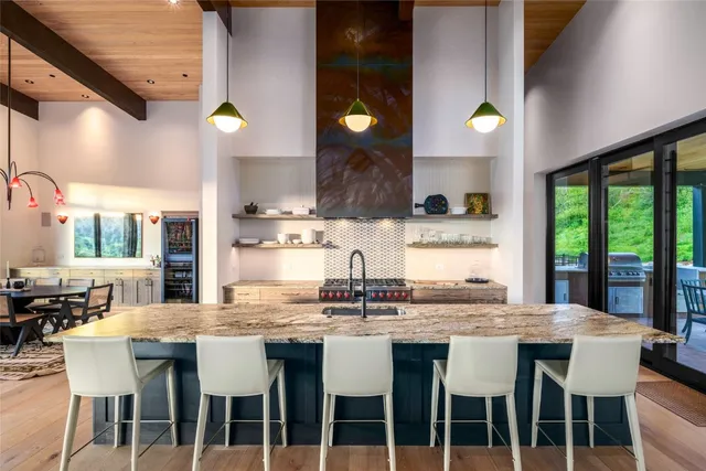 a kitchen with granite countertop a sink and a stove
