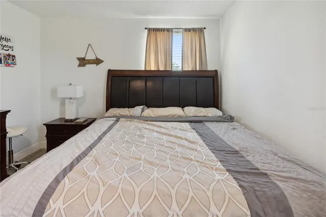 a bedroom with furniture and a mirror on dresser