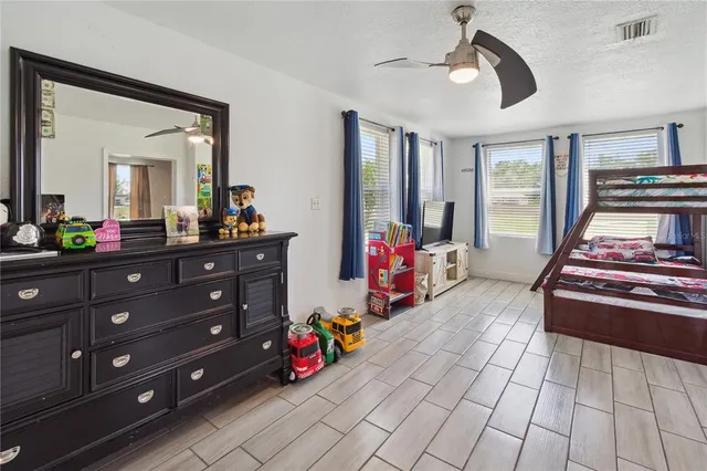 a bed room with a bed and a television