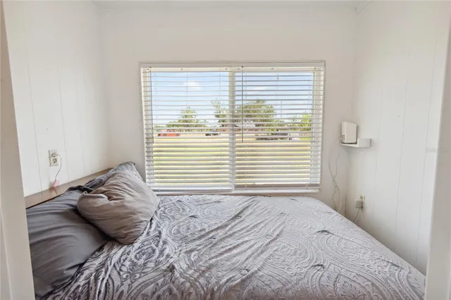 a living room with furniture and a gym machine