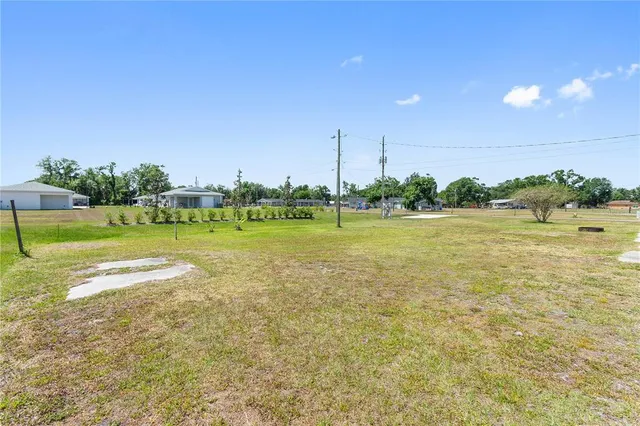 a view of a swimming pool with a yard