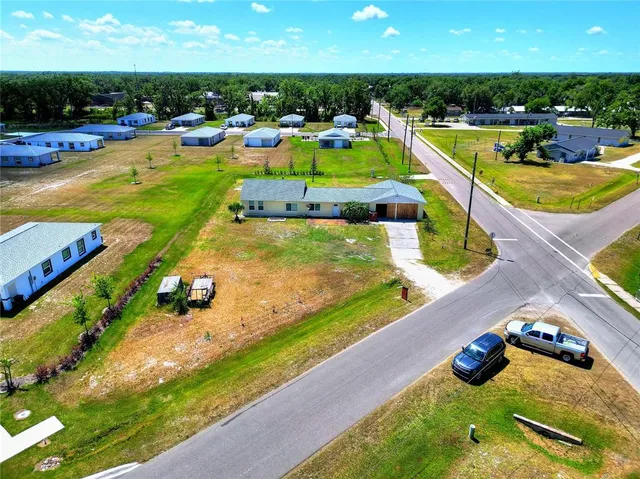 an aerial view of a house with swimming pool yard and outdoor seating