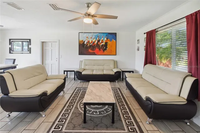 a living room with furniture and a large window