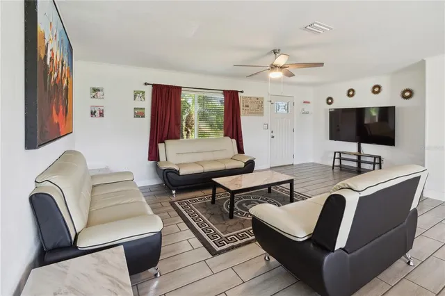 a living room with furniture and a flat screen tv