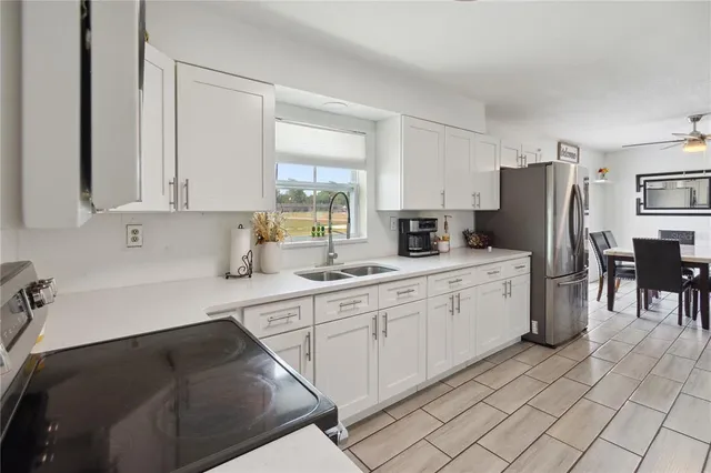 a kitchen with cabinets and chairs